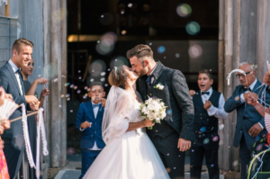 bride and groom kiss
